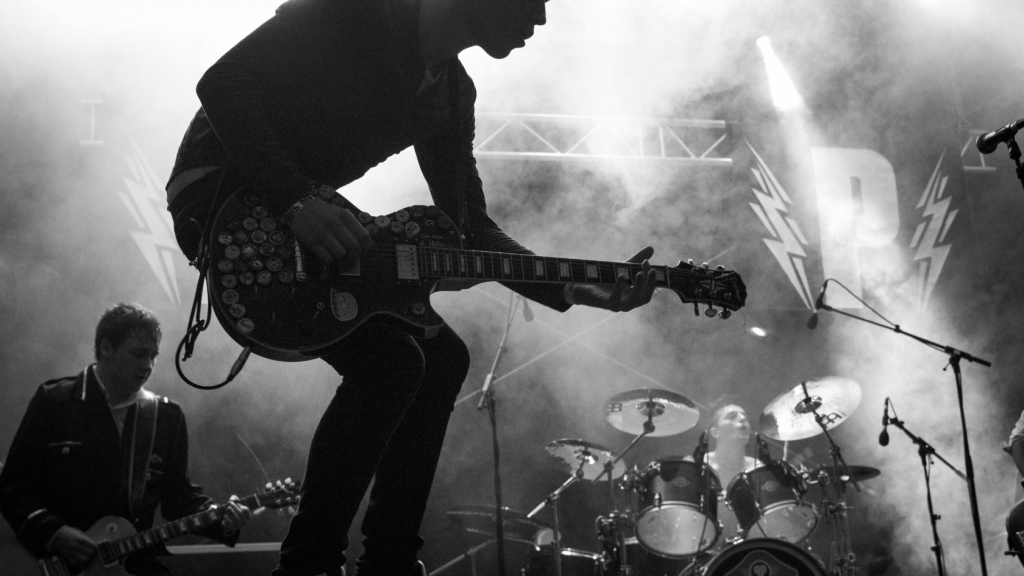 Guitar player with band on stage