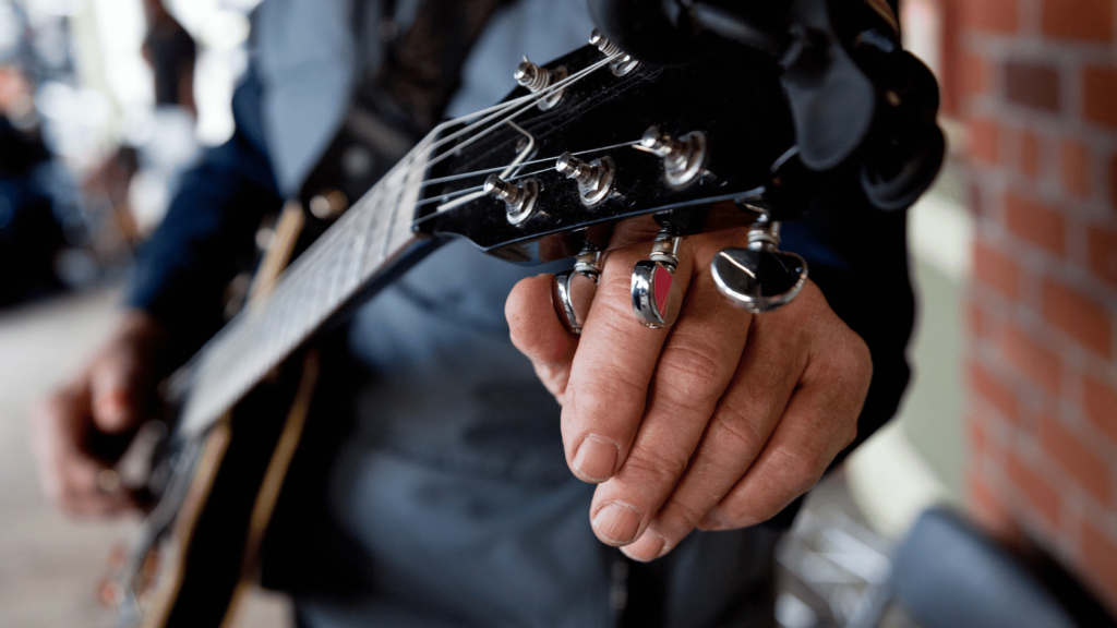 Guitar player tuning a guitar