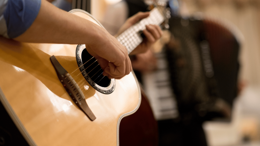 Guitar player playing an acoustic guitar