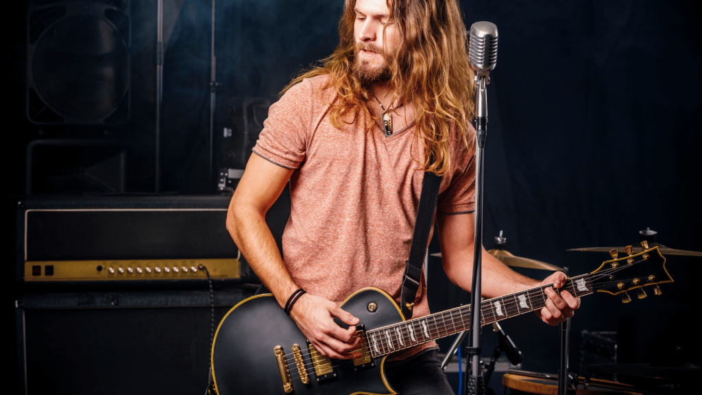 Guitar player on stage with amplifiers