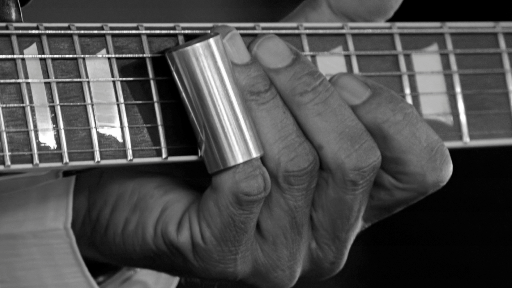 Guitar player using a slide