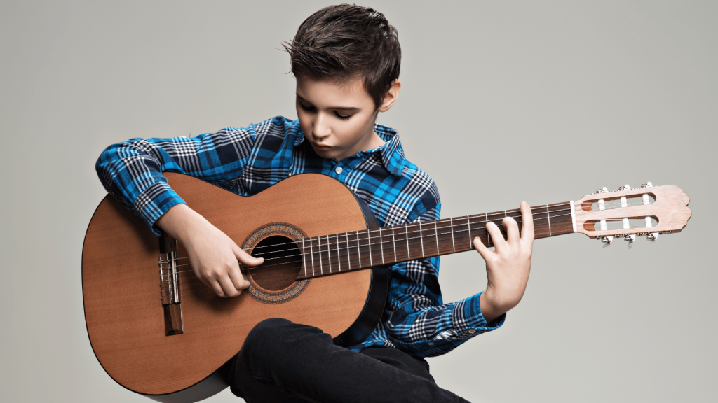 Young guitar player practicing